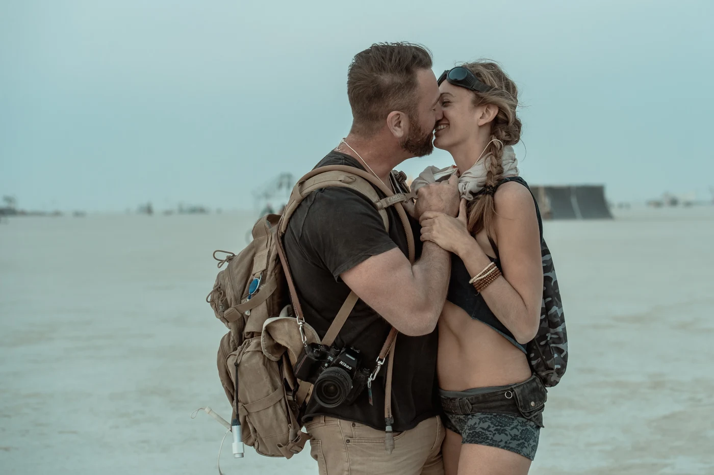 Couple embracing in the desert, cinematic teal tones