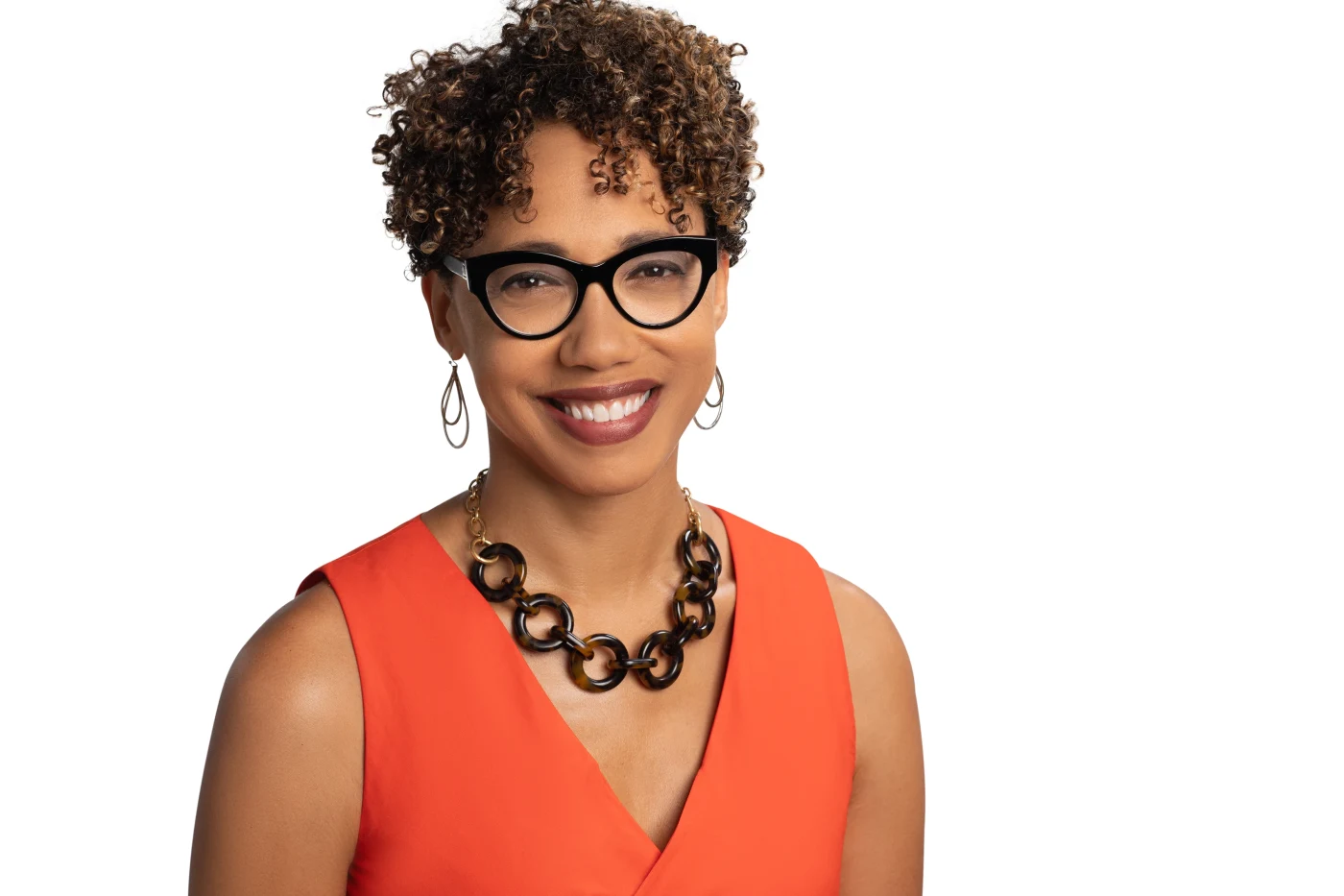 Smiling woman in orange with statement necklace