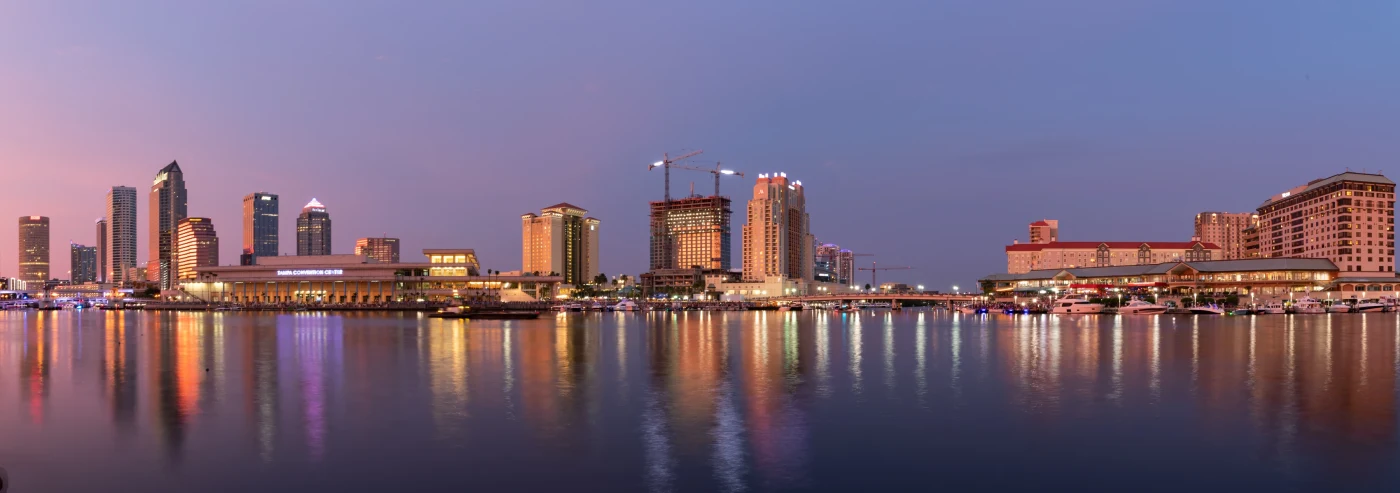 Panorama of the downtown Tampa skyline reflected in the Hillsborough River at dusk